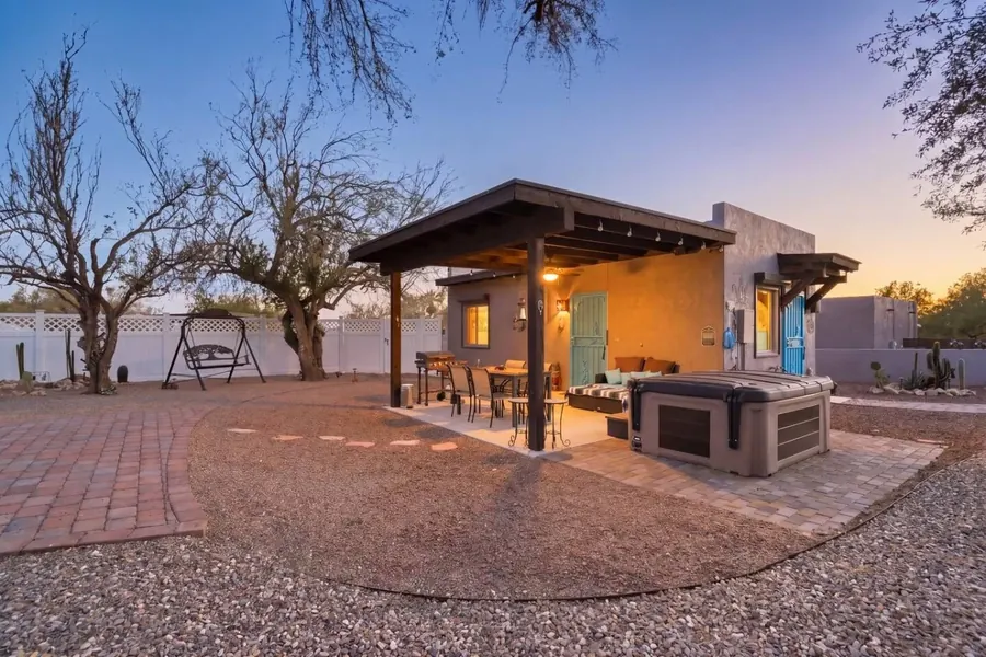 Patio with a hot tub, swing and dining table